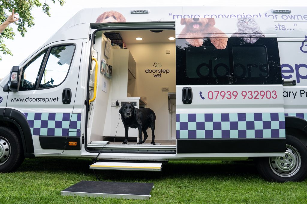 mobile vet practice with dog standing in doorway