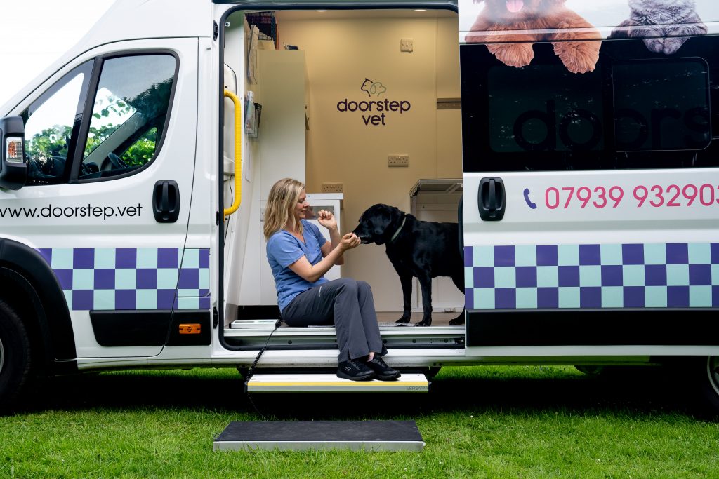 vet and dog in mobile vet van